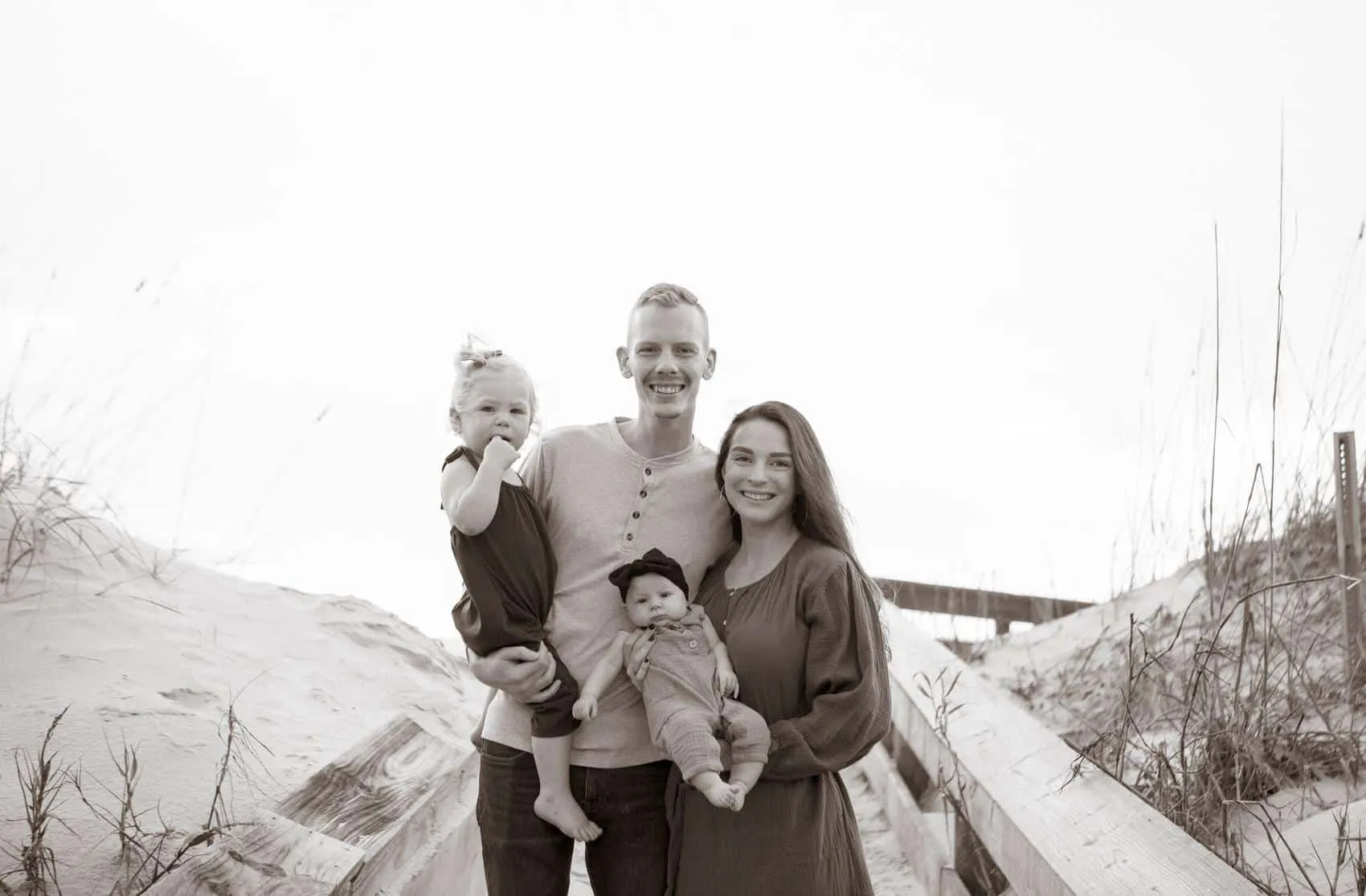 Family of four together at the 3rd Street access on Atlantic Beach in Jacksonville
