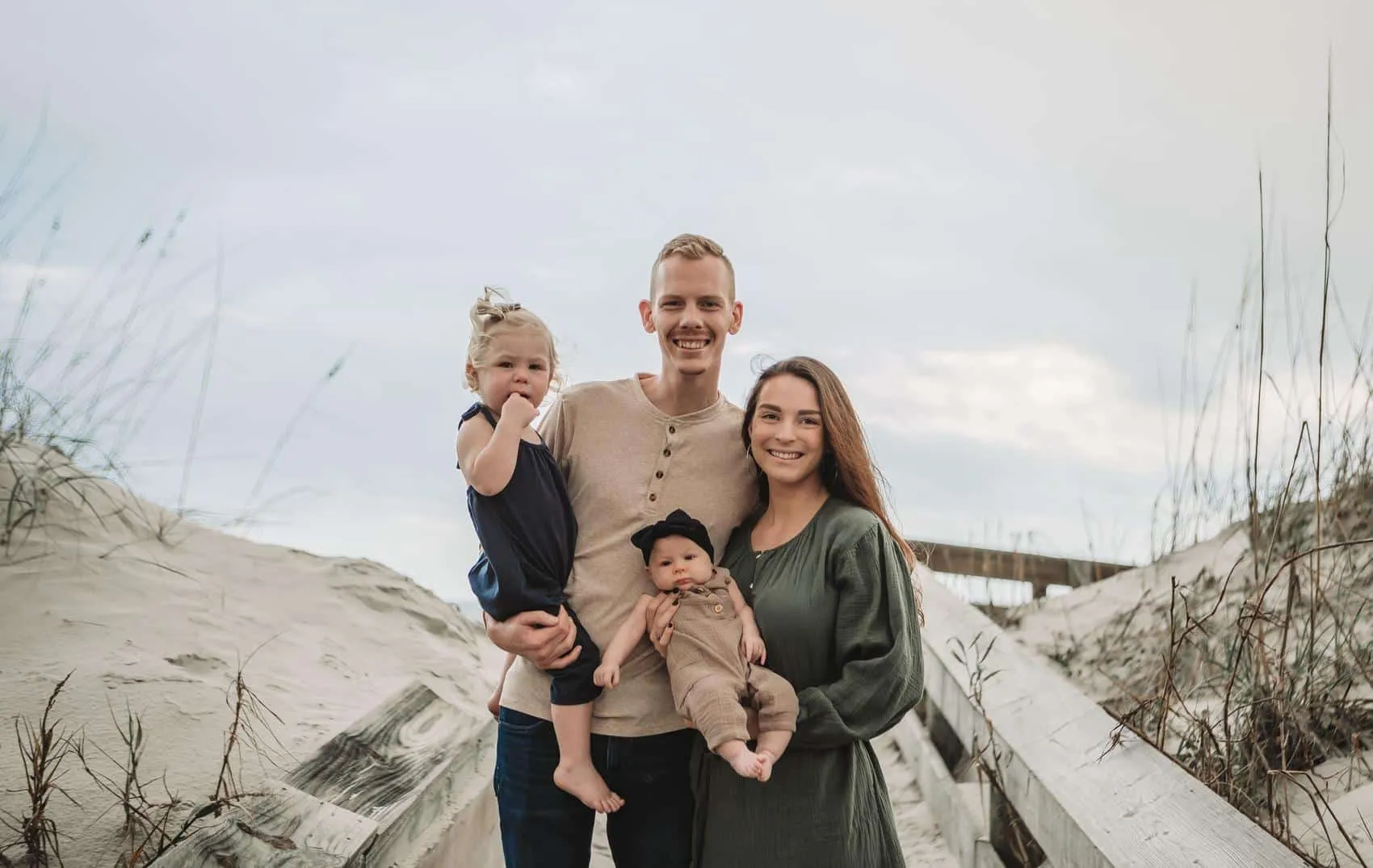 Family of four together at the 3rd Street access on Atlantic Beach in Jacksonville