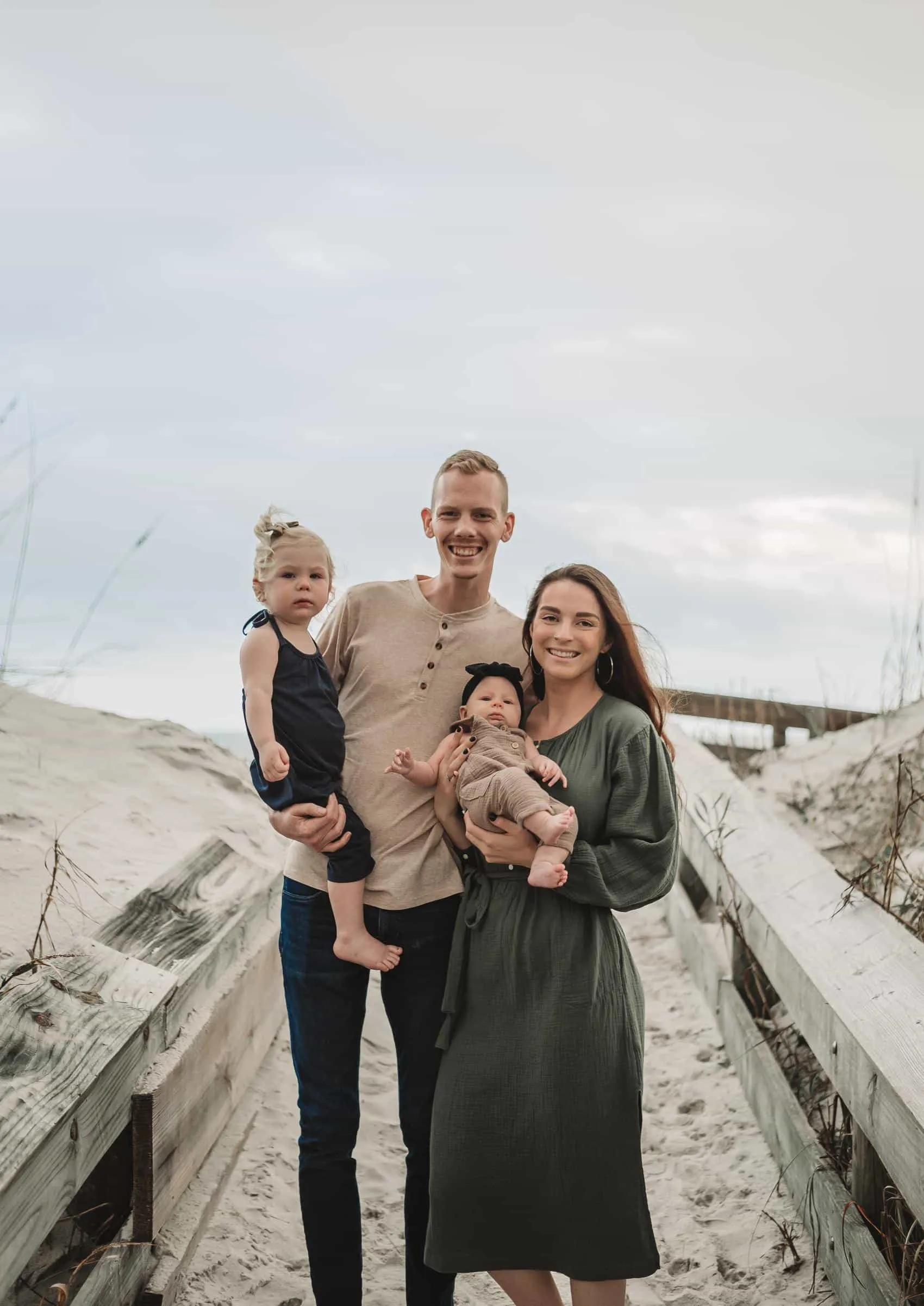 Family of four together at the 3rd Street access on Atlantic Beach in Jacksonville