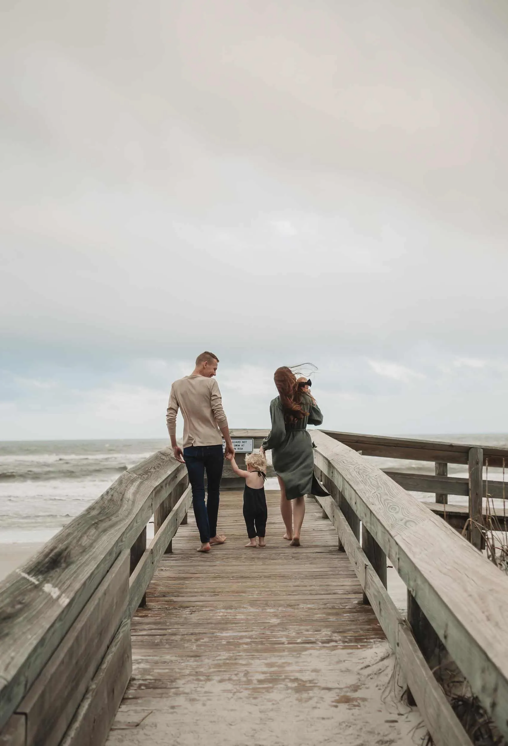 Family of four together at the 3rd Street access on Atlantic Beach in Jacksonville