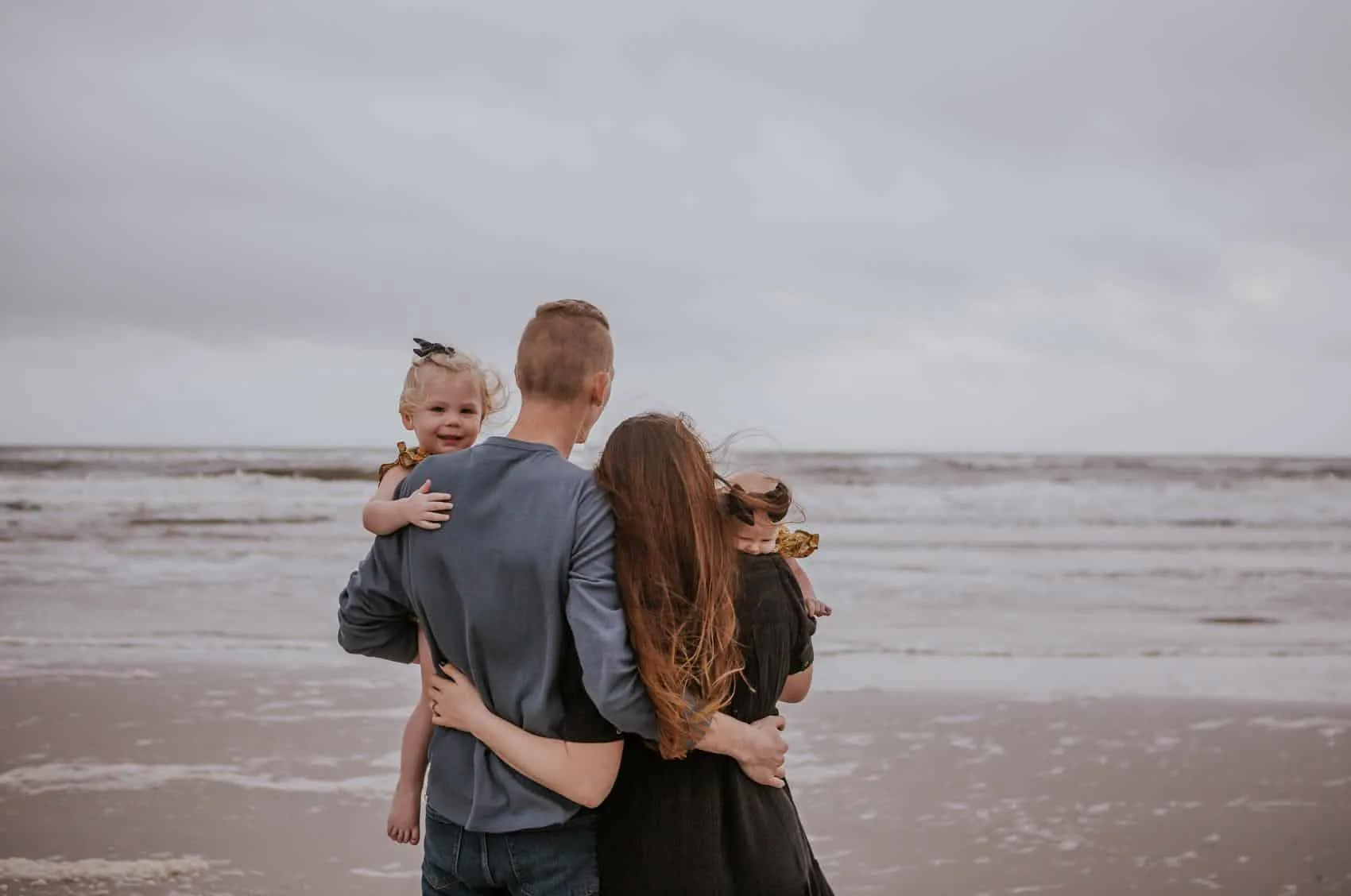 Family of four together at the 3rd Street access on Atlantic Beach in Jacksonville