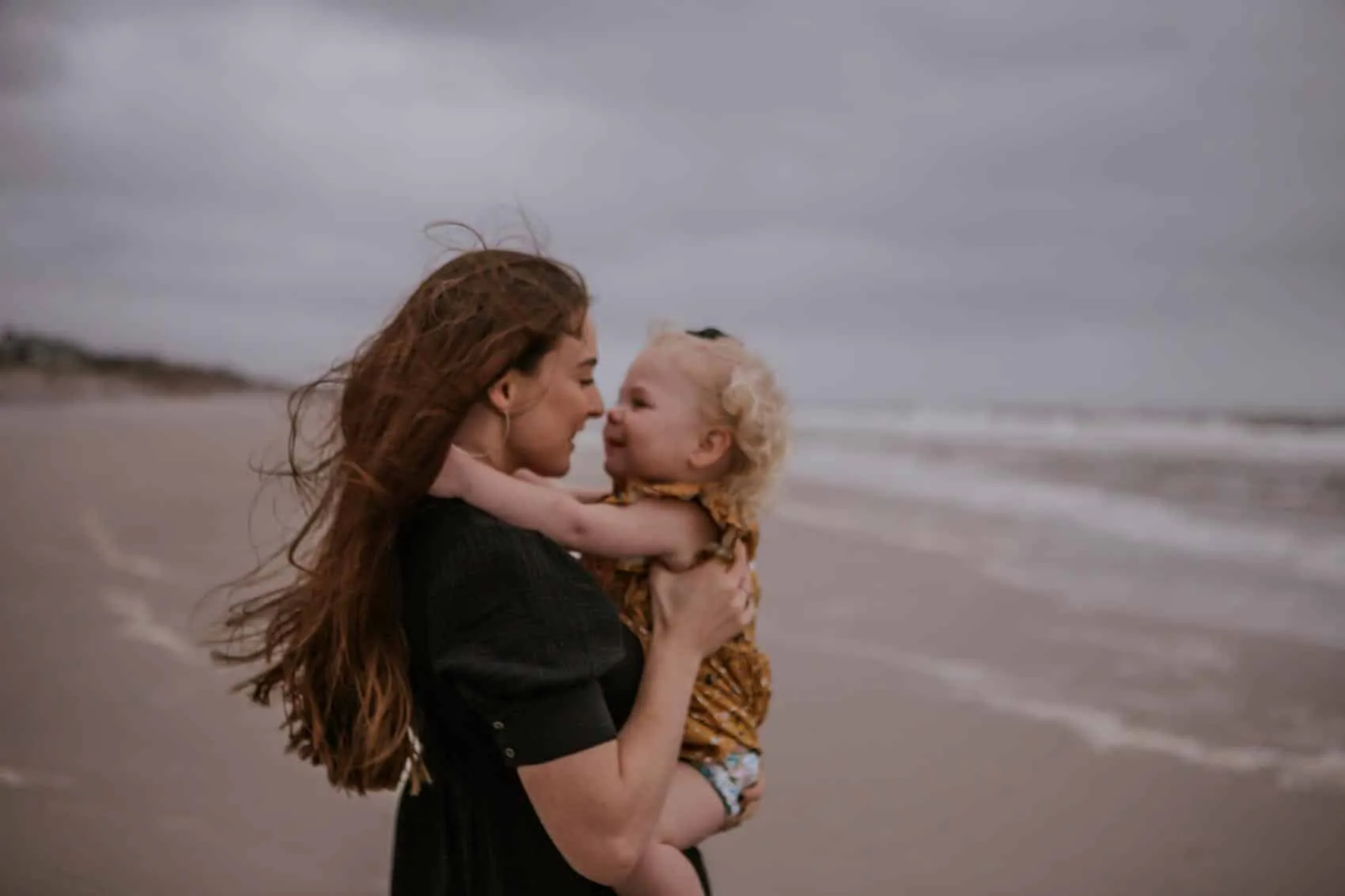Family of four together at the 3rd Street access on Atlantic Beach in Jacksonville