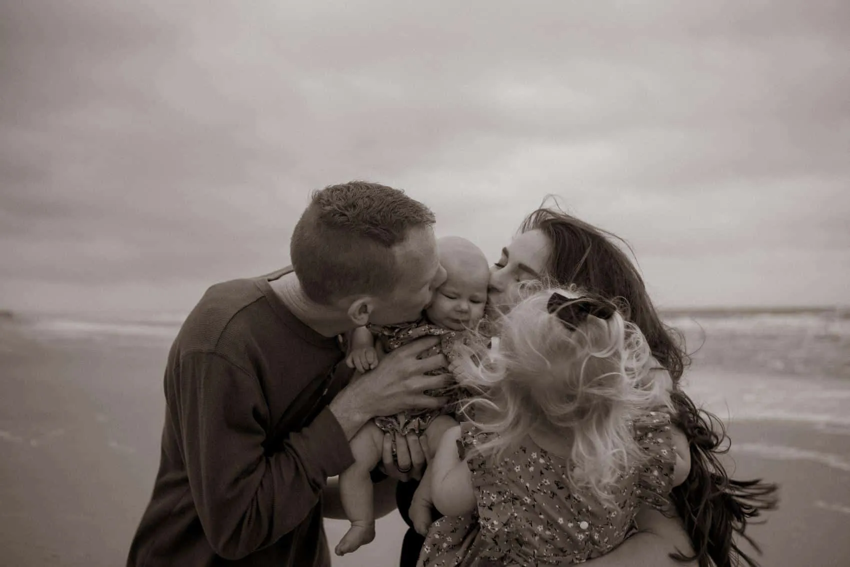 Family of four together at the 3rd Street access on Atlantic Beach in Jacksonville