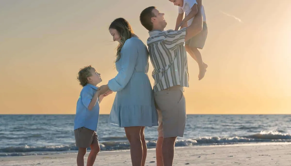 Family in coordinating outfits on Siesta Key beach