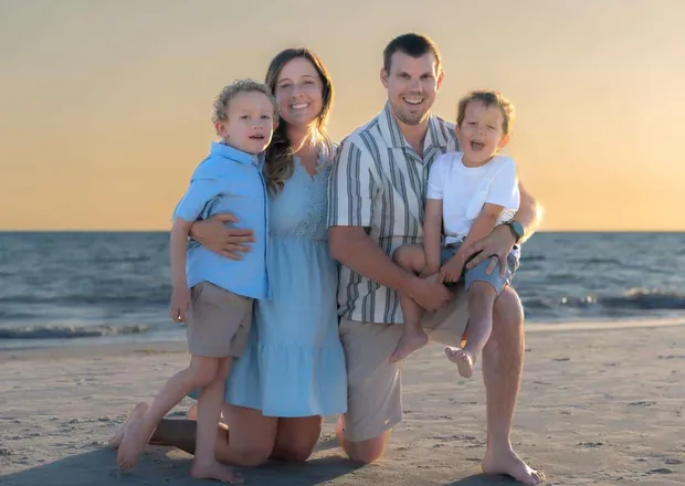 Expecting family enjoying a soft-light outdoor maternity session