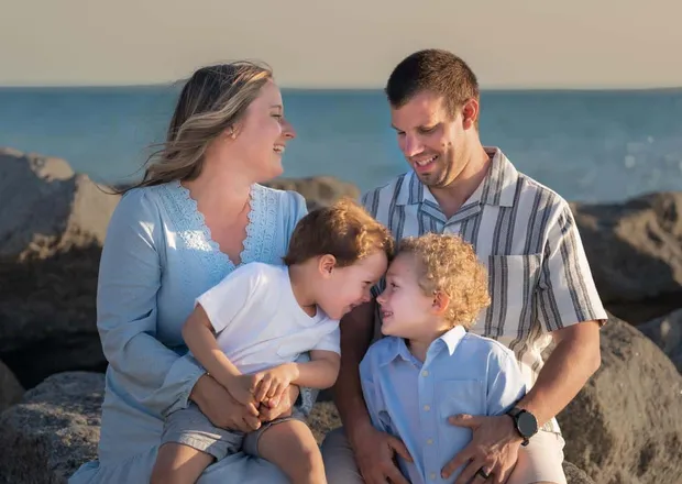Young family during a relaxed outdoor portrait session in soft natural light