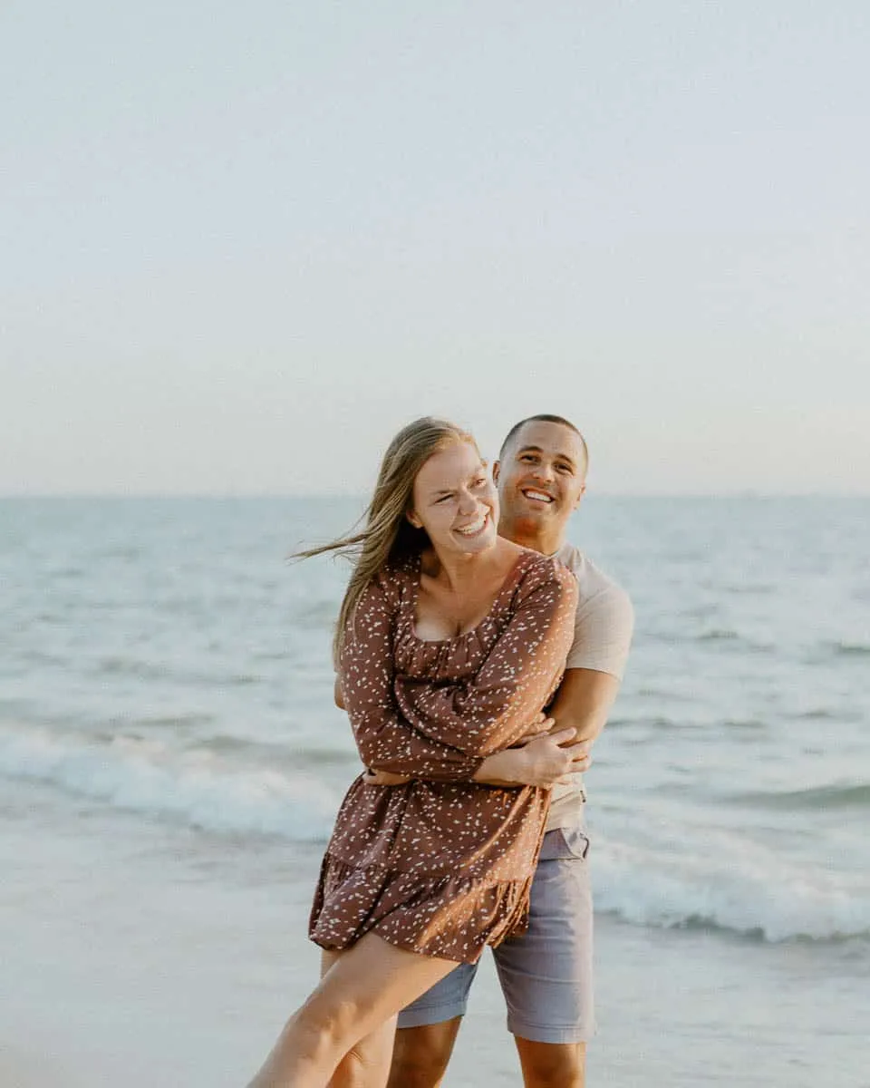 Couple embracing at sunset on Siesta Key Beach in spring