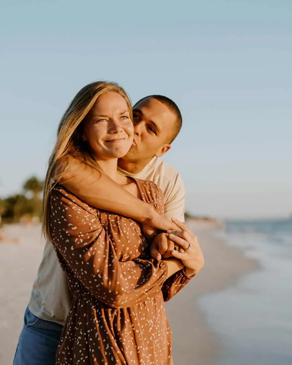 Couple embracing at sunset on Siesta Key Beach in spring
