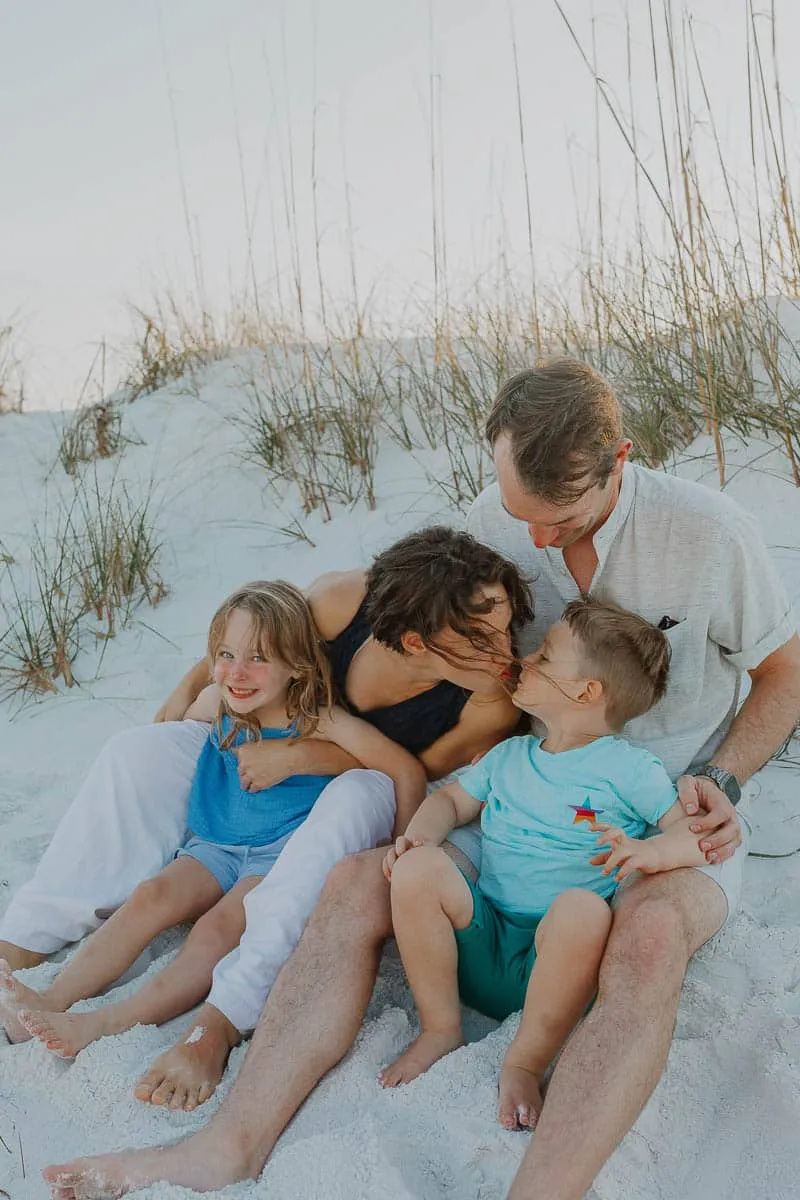 Three generations of a family together on the sand at Siesta Beach in the early evening