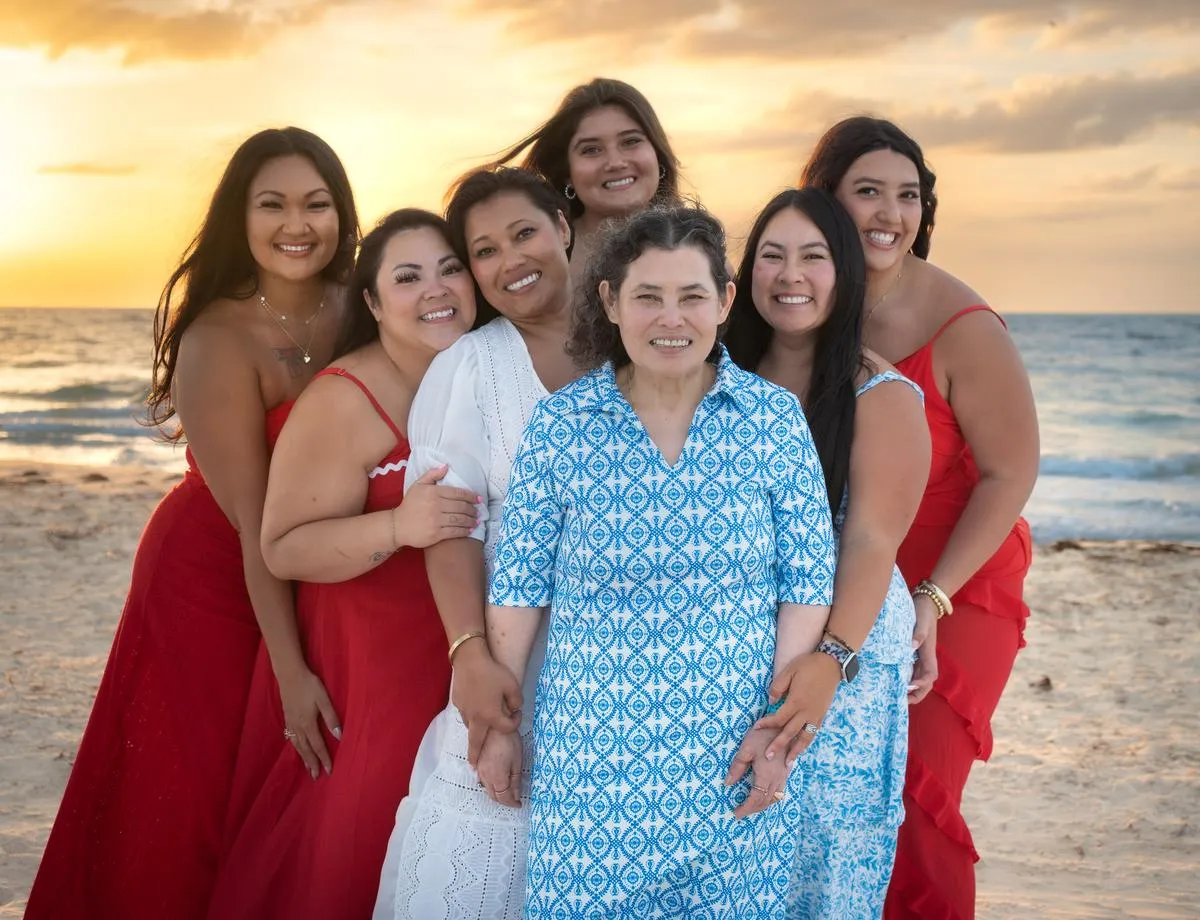 Large extended family gathered on the sand at Bean Point, Anna Maria Island, at sunset