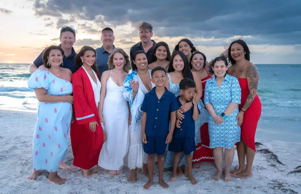 Extended family together on the beach at sunset on Anna Maria Island